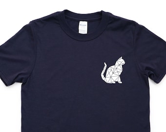 May include: A navy blue t-shirt with a white geometric cat design on the front.