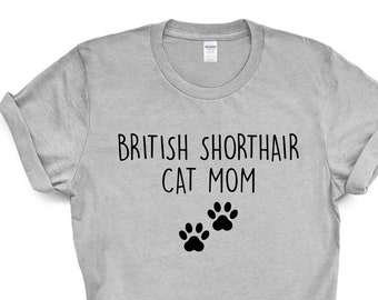 May include: Gray t-shirt with the text "British Shorthair Cat Mom" and two black paw prints.