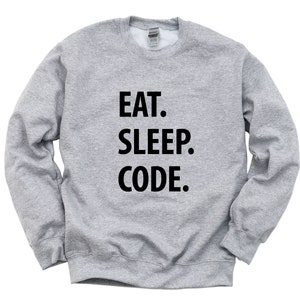 May include: A grey sweatshirt with the text "EAT. SLEEP. CODE." printed in black.