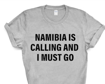 May include: A gray t-shirt with black text that reads "Namibia is calling and I must go."
