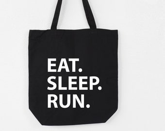 Puede incluir: Bolsa de tela negra con texto blanco que dice "EAT. SLEEP. RUN."