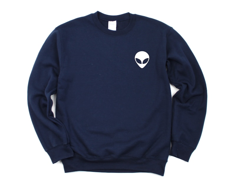 May include: A navy blue sweatshirt with a white alien face graphic on the front.