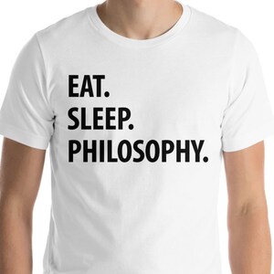 May include: White t-shirt with black text that reads "EAT. SLEEP. PHILOSOPHY."