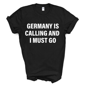 May include: Black t-shirt with white text that reads "Germany is calling and I must go."