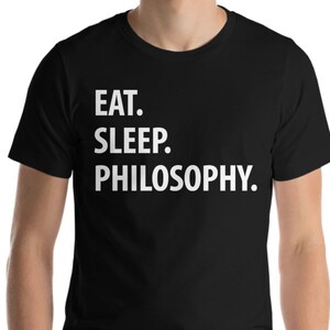 May include: Black t-shirt with white text that reads "EAT. SLEEP. PHILOSOPHY."