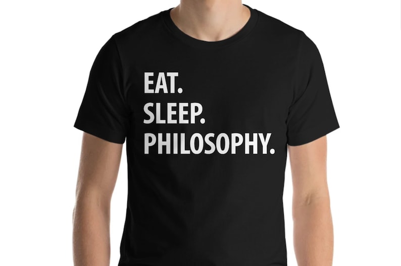 May include: Black t-shirt with white text that reads "EAT. SLEEP. PHILOSOPHY."