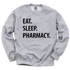 May include: A gray sweatshirt with the text "EAT. SLEEP. PHARMACY." printed in black.