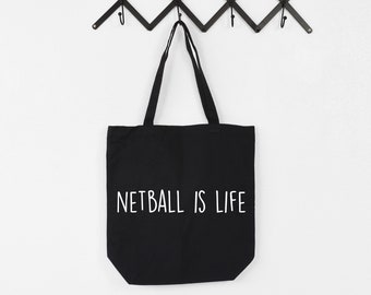 May include: Black canvas tote bag with white text that reads "Netball is Life".