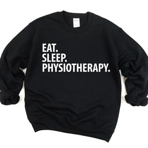 May include: Black sweatshirt with white text that reads "Eat. Sleep. Physiotherapy."