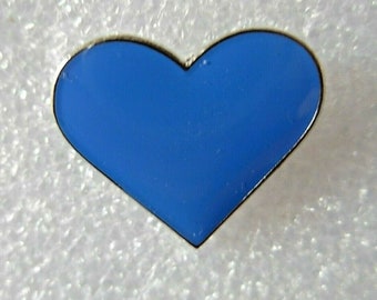 Blue heart shaped pin badge. Standard or Deluxe versions. Metal. Enamel