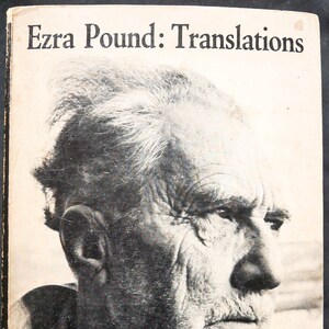 May include: Black and white photo of Ezra Pound, a famous poet, on the cover of a book titled "Ezra Pound: Translations". The book is a New Directions Paperback.