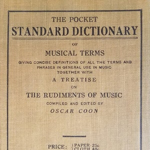 May include: A yellow book titled "The Pocket Standard Dictionary of Musical Terms" with the text "Giving concise definitions of all the terms and phrases in general use in music together with a treatise on The Rudiments of Music Compiled and Edited by Oscar Coon" and the price "Paper 25c Cloth 40c Prices in U.S.A.". The book is published by Carl Fischer, Inc. with addresses for Boston and Chicago.