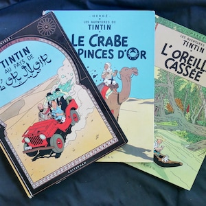 Les Aventures de Tintin: Les Crabe aux Pinces D&#39;Or, L&#39;Orielle Cassée Tintin au Pays de L&#39;or Noir (1949, 1963) by Hergé. Hardcovers in French