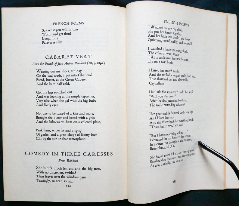 May include: A page from a book of French poetry by Jean Arthur Rimbaud. The page features two poems, "Cabaret Vert" and "Comedy in Three Caresses". The text is printed in black ink on white paper.