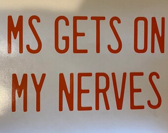 May include: White background with the orange text "MS GETS ON MY NERVES". The text is in a bold, sans-serif font. The image is a close-up shot, highlighting the message.