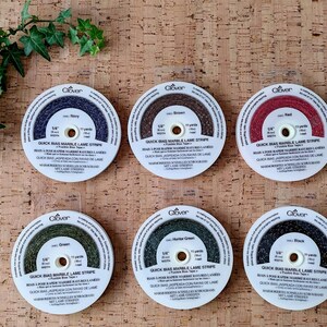 May include: Six spools of Clover Quick Bias Marble Lame Stripe in various colors: Navy, Brown, Red, Green, Hunter Green, and Black. Each spool is 1/4 inch wide and contains 11 yards of bias tape.