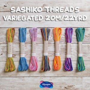 May include: Seven bundles of variegated Sashiko threads in various colours, including yellow, blue, pink, and green. Each bundle is wrapped with a paper label and contains 20 metres of thread. The text "Sashiko Threads Variegated 20M/22YRD" is at the top.