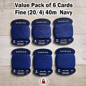 May include: A value pack of six navy blue Sashiko thread cards. Each card displays a spool of fine thread, 40 meters in length, made of 100% cotton. The packaging includes the brand name and product details.