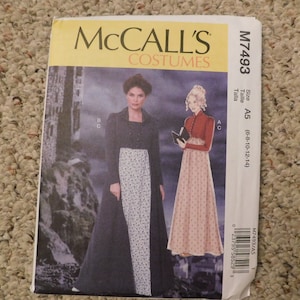 May include: McCall's Costumes sewing pattern M7493. The pattern features illustrations of historical costumes, including a long dress with a floral print and a red jacket. The size is A5 (6-8-10-12-14).