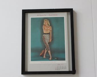 May include: A framed vintage calendar featuring a woman in a leopard print outfit holding a musical instrument. The calendar is for September 1947.