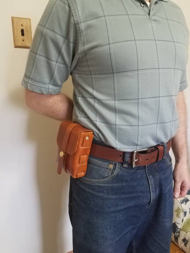One with solid brass snap and screw rivets. Leather ammo pouches