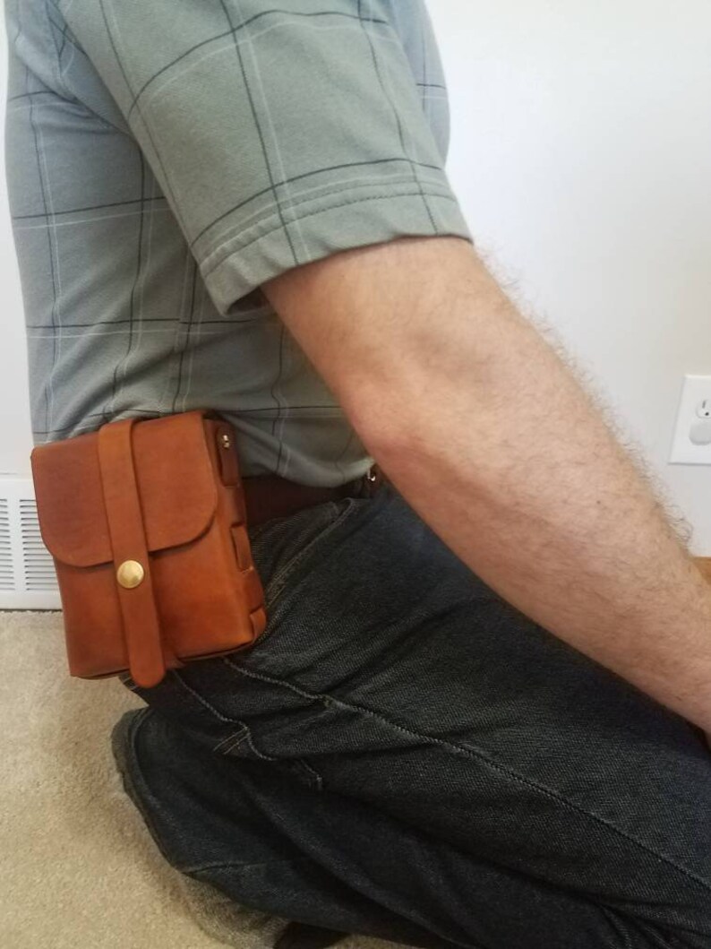 One with solid brass snap and screw rivets. Leather ammo pouches