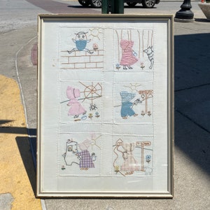 Hand stitched nursery rhyme themed artwork quilt for child or doll bed framed under glass