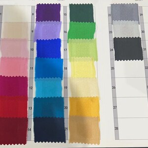 May include: A color chart with 35 fabric swatches. The swatches are arranged in rows and columns, with each swatch numbered. The swatches are a variety of colors, including white, beige, pink, red, blue, green, yellow, and black.