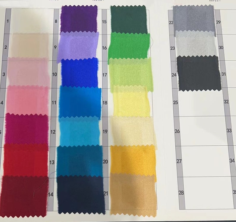 May include: A color chart with 35 fabric swatches. The swatches are arranged in rows and columns, with each swatch numbered. The swatches are a variety of colors, including white, beige, pink, red, blue, green, yellow, and black.
