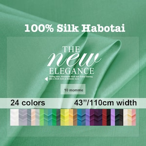 May include: A close-up of a green silk fabric with the text "100% Silk Habotai" and "THE new ELEGANCE" in white. The fabric is 43 inches wide and comes in 24 colours. The text "Rising stars Alessandra Rich and Prabal Gurung take a fresh look at feminine style" is also visible.