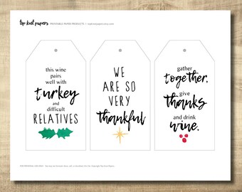 May include: Three printable gift tags with Thanksgiving-themed text. The first tag says "This wine pairs well with turkey and difficult relatives". The second tag says "We are so very thankful". The third tag says "Gather together, give thanks and drink wine."
