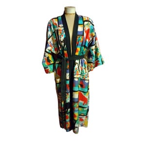 May include: A long, colorful robe with a black sash. The robe has a geometric pattern with animals and plants.