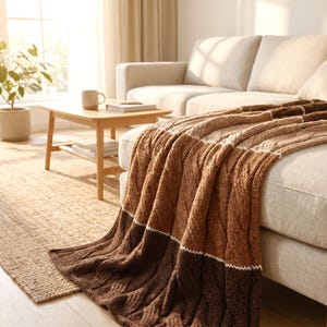 handmade knit verino wool throw blanket on a coach in a cozy modern living room