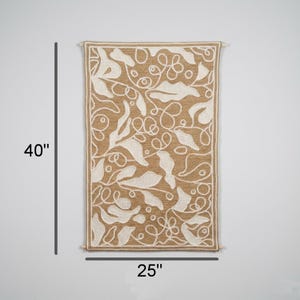 Textured fiber wall art with embroidered leaf motif and soft natural color palette