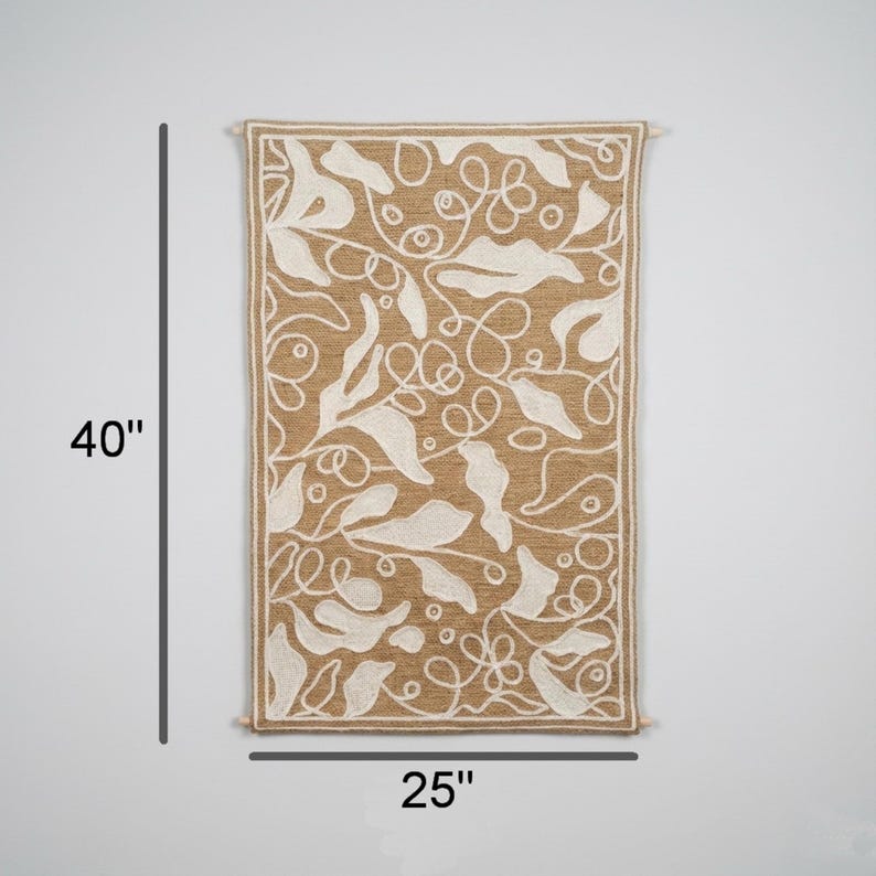 Textured fiber wall art with embroidered leaf motif and soft natural color palette