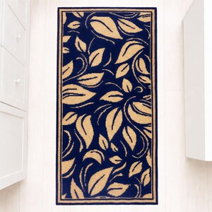 A navy blue and beige patterned rug with a yellow floral design. The rug has a border around the edges.