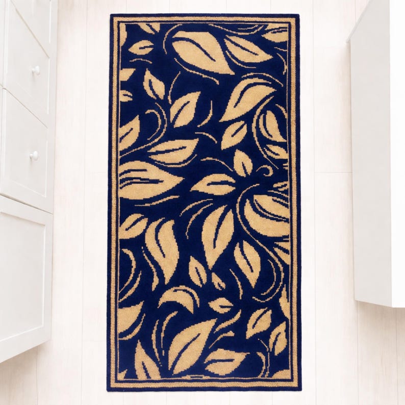 A navy blue and beige patterned rug with a yellow floral design. The rug has a border around the edges.