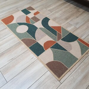 Full view of the rectangular embroidered wool rug.