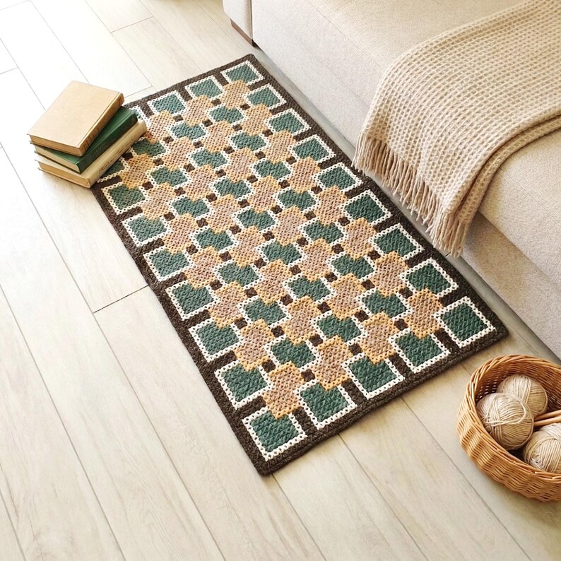 Wool accent rug in Beige, Brown, Green and Teal colors positioned next to a sofa, geometric design defining the space