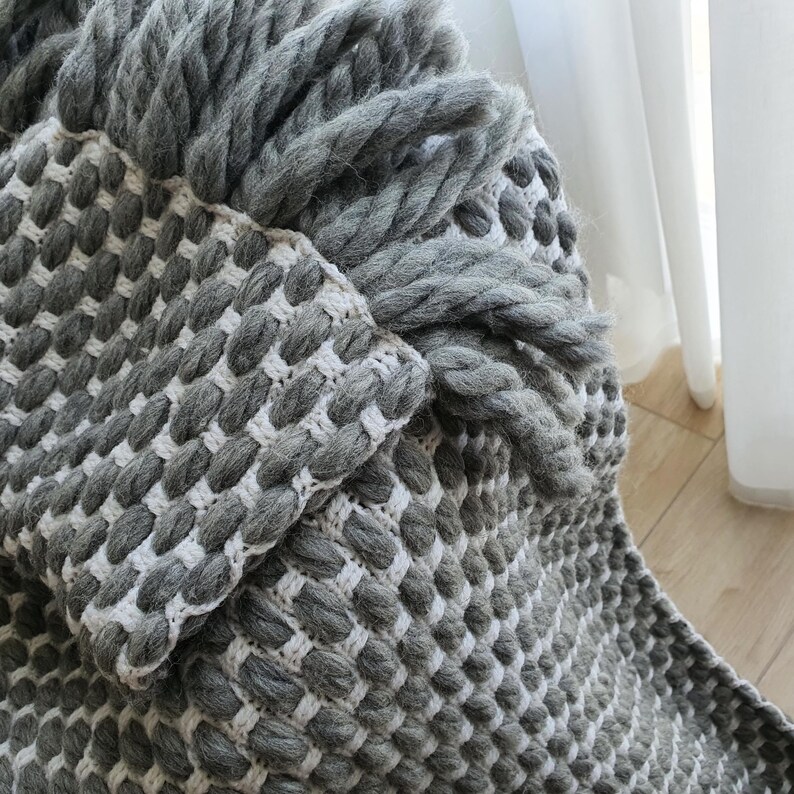 Chunky wool blanket made of thick wool yarn with visible structure and natural imperfections