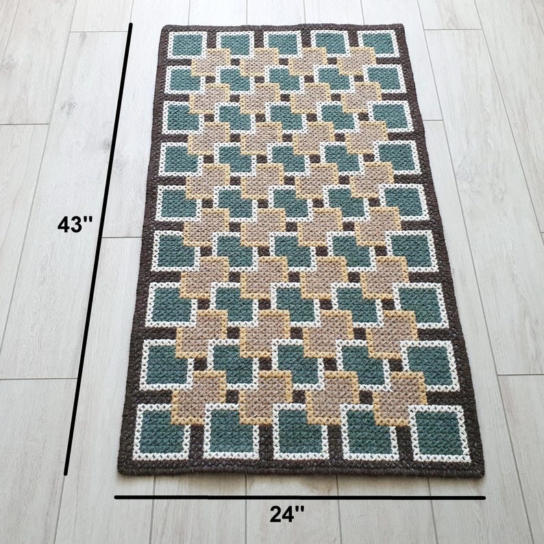 Full view of handmade wool rug in Beige, Brown, Green and Teal, geometric pattern, rectangular shape on light floor