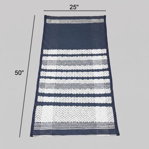 Full size view of cotton woven rug with horizontal stripe composition on gray background.