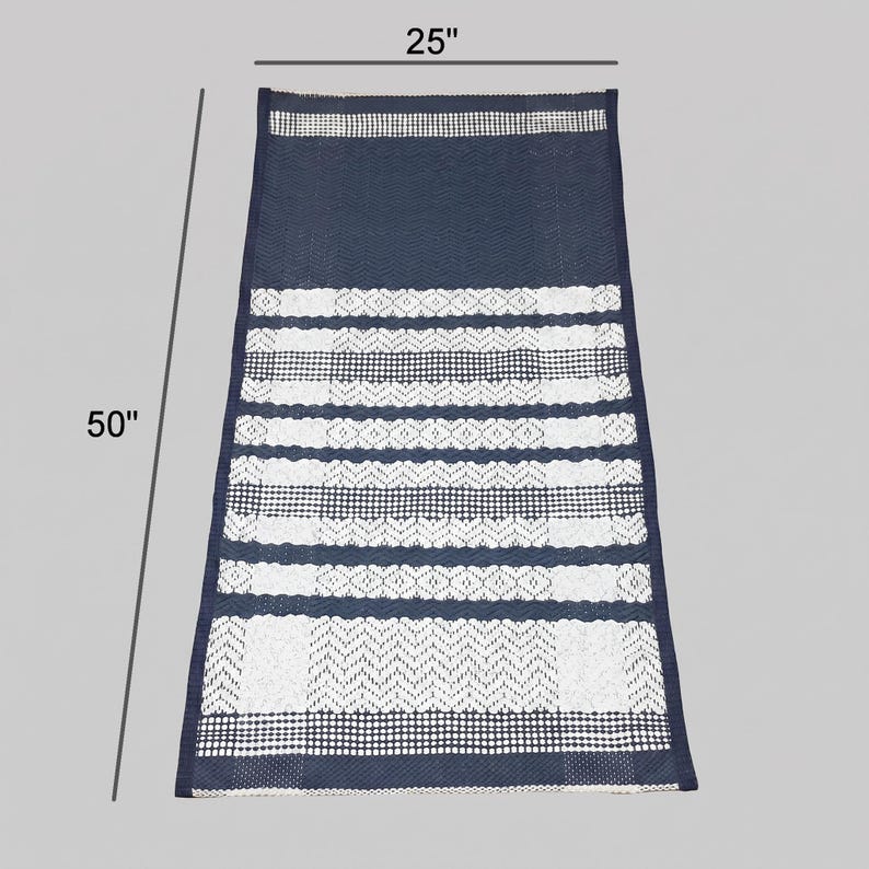 Full size view of cotton woven rug with horizontal stripe composition on gray background.