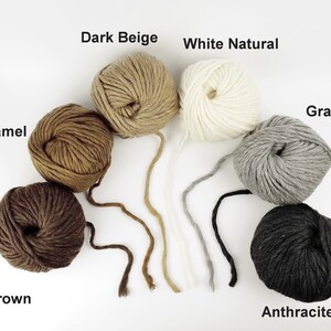 May include: Balls of yarn in various shades of brown, beige, grey, and black. The colours are labelled "Camel", "Dark Beige", "White Natural", "Grey", "Brown", and "Anthracite".