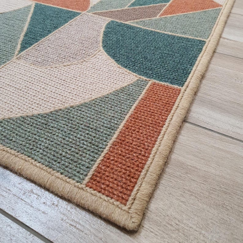 Handmade wool rug with abstract pattern on floor.