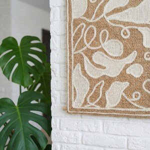 Embroidered wall panel with raised wool pattern and natural leaf-inspired shapes