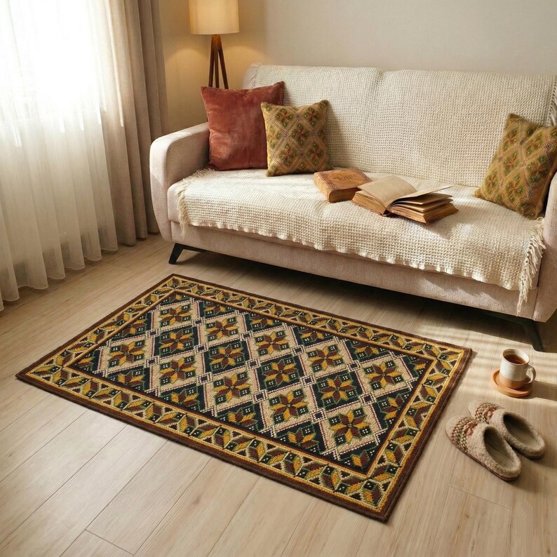 Rectangular area rug with a Ukrainian pattern in beige, black, yellow, and burgundy. The rug is placed on a light wood floor, partially a beige sofa. The rug's border features a repeating folk design.