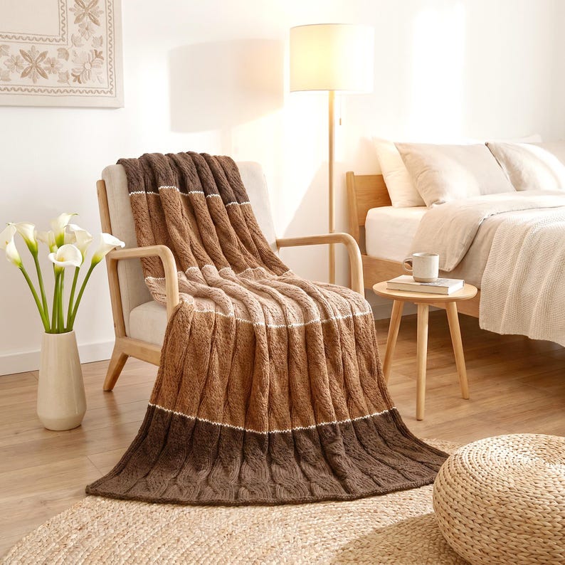 Handmade Knitted Striped Merino Wool Throw Blanket Brown Beige on an armchair in a contemporary bedroom