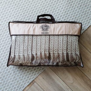 A suitcase for brand packaging of handmade crochet blanket.