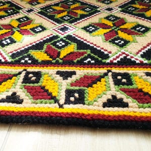 close-up nexture of a wool rug with Ukrainian ornament, handmade